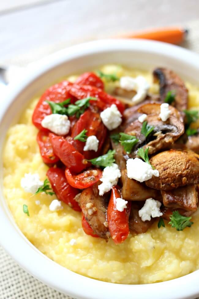 Instant Pot Creamy Polenta with Roasted Tomatoes--easiest to make polenta ever, thanks to your electric pressure cooker! Creamy polenta is served hot with balsamic drizzled roasted tomatoes, mushrooms and garlic and then topped with tart goat cheese. A perfect meatless meal that will leave you feeling satisfied. 