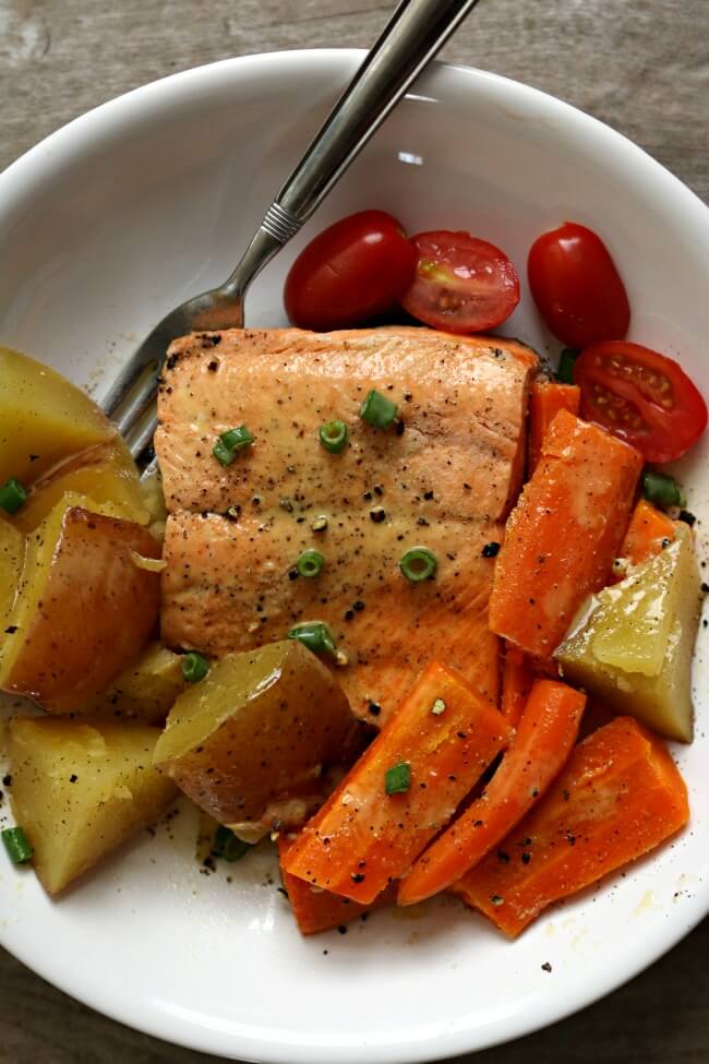 Instant Pot Lemon Butter Garlic Salmon with Homestyle Vegetables--flaky wild Alaska salmon is steamed on the top of red potatoes and carrots in your electric pressure cooker and topped with garlic, fresh lemon juice and butter. A one pot meal that is healthy and delicious!