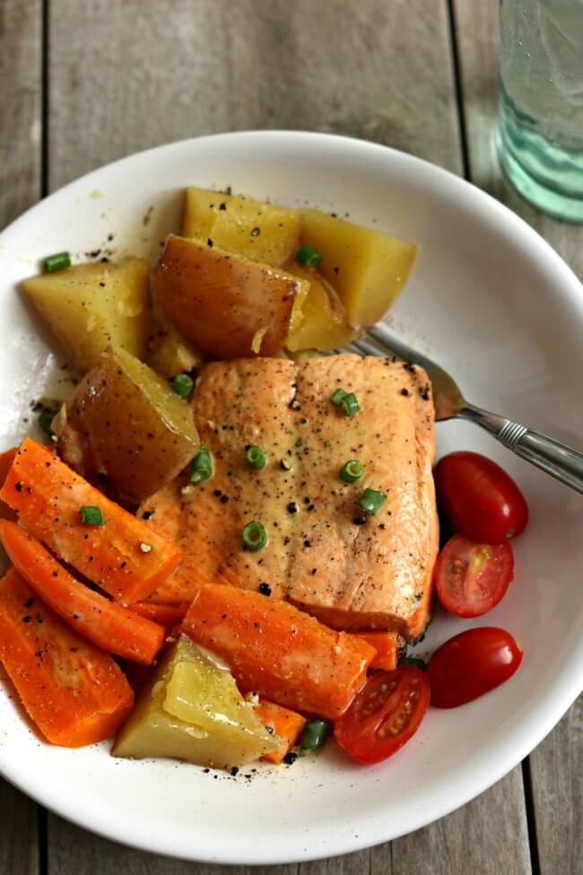 Instant Pot Lemon Butter Garlic Salmon with Homestyle Vegetables--flaky wild Alaska salmon is steamed on the top of red potatoes and carrots in your electric pressure cooker and topped with garlic, fresh lemon juice and butter. A one pot meal that is healthy and delicious!
