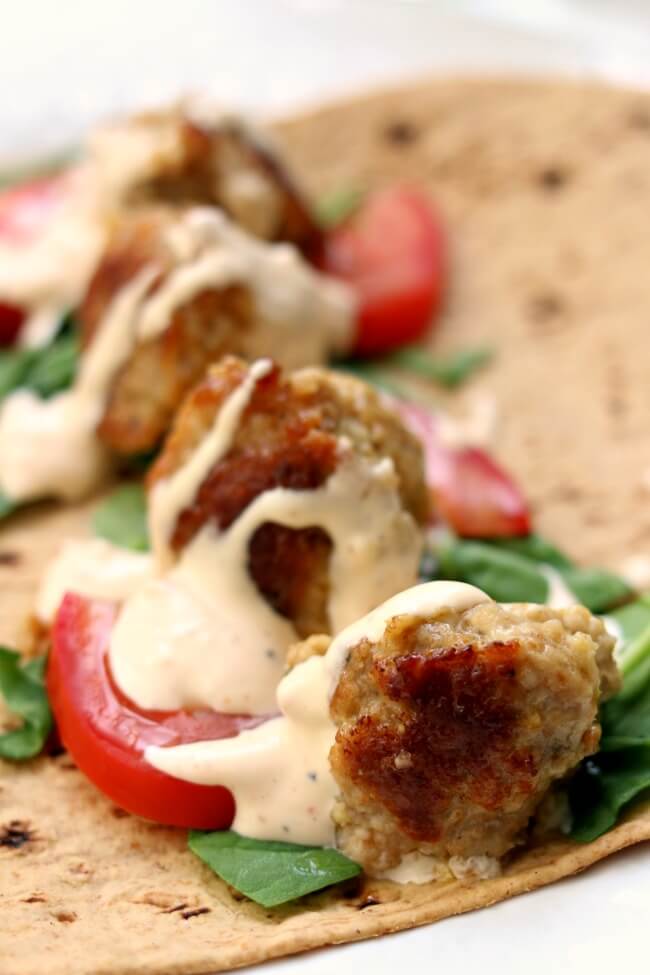 Instant Pot Lemon Chicken Meatball Wraps with Spicy Garlic Sauce--flavorful lemon chicken meatballs are served rolled up in flatbread with lettuce, tomato and a sour cream/mayo mixture with lots of garlic and sriracha flavor. A perfect summer meal! 