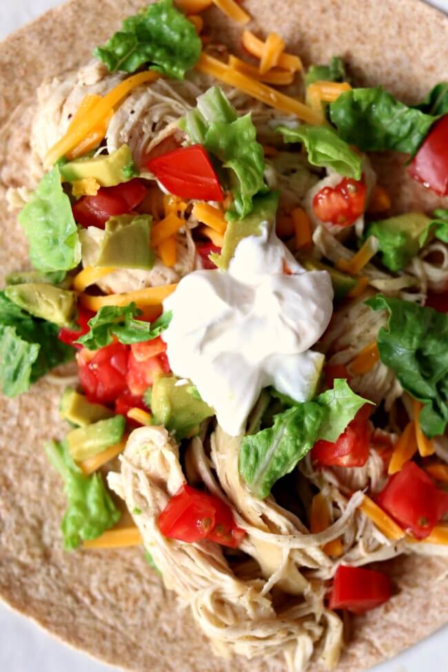 Instant Pot/Slow Cooker 3-Ingredient Lime Chicken Tacos (from frozen)--this is the easiest and tastiest shredded chicken that you can serve in tacos (or other ways). The best part is that you can use frozen chicken and it takes about 2 minutes of prep time.  
