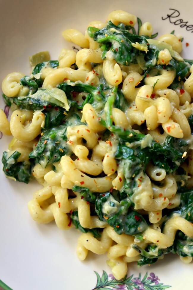 Instant Pot Spinach Artichoke Mac and Cheese--creamy, cheesy pasta with fresh spinach and chopped artichokes is a perfect way to indulge while sneaking in some greens.Â 