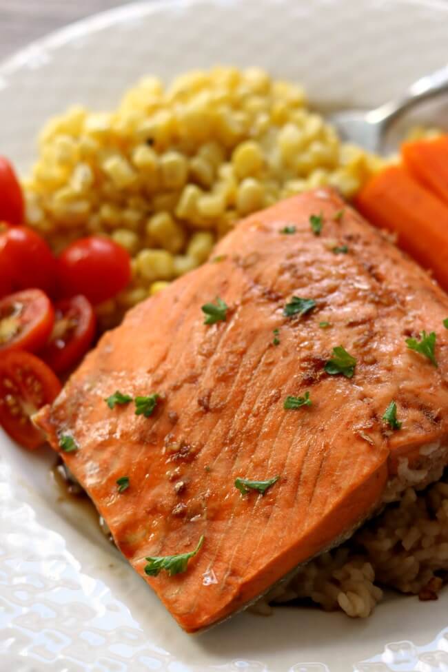 Instant Pot Teriyaki Salmon and Rice--frozen salmon fillets are thrown into your electric pressure cooker with some rice and cooked until flaky. This is such an easy and fast way to make salmon. Serve your salmon and rice with veggies and you have a complete meal. 