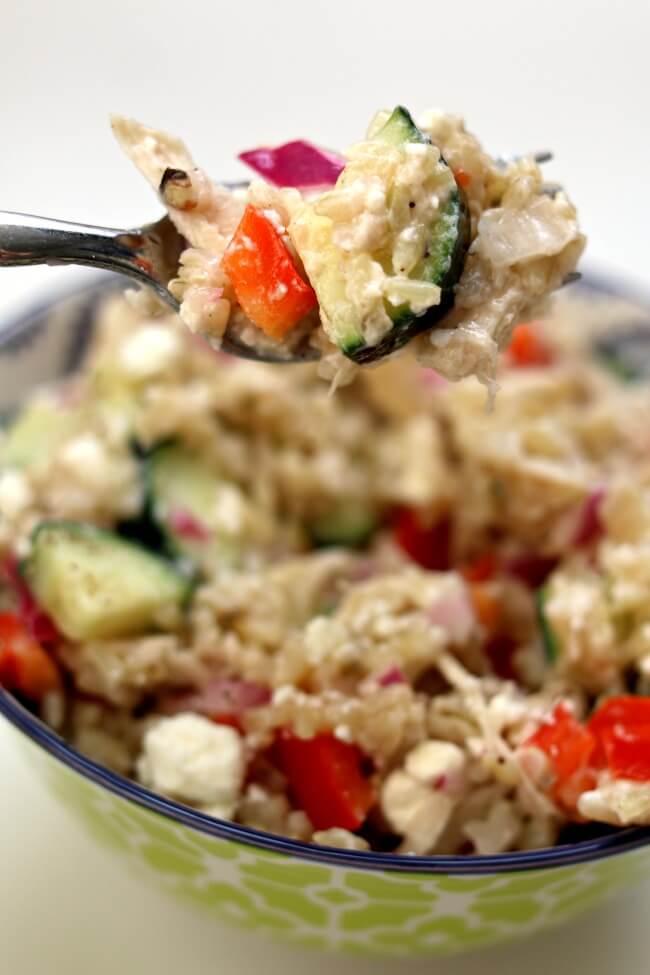Instant Pot Greek Chicken Rice Bowls--brown rice and chicken are tossed with a lemon juice, olive oil, fresh garlic and vinegar dressing. Diced cucumber, red bell pepper, red onion and feta cheese are stirred into the rice to complete the one pot meal.Â 