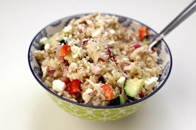 Instant Pot Greek Chicken Rice Bowls--brown rice and chicken are tossed with a lemon juice, olive oil, fresh garlic and vinegar dressing. Diced cucumber, red bell pepper, red onion and feta cheese are stirred into the rice to complete the one pot meal. 