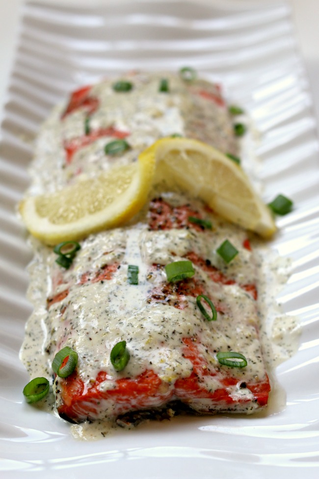Roasted Salmon with Creamy Garlic Lemon Sauce--flaky, tender Alaska salmon with a zesty lemon garlic mayonnaise sauce drizzled on top. A super fast and easy recipe that tastes like it belongs in a fancy restaurant. 