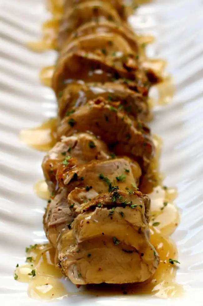 Instant Pot Pork Tenderloin with Gravy--tender slices of pork tenderloin are drizzled with a savory gravy. It is a fancy meal that is super easy to make and it just takes minutes in your electric pressure cooker. 