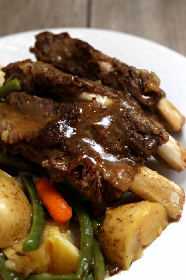 Slow Cooker Beef Spare Ribs--fall off the bone tender spare ribs served with gravy that seem like a lot of effort but are actually super easy and hands off. 
