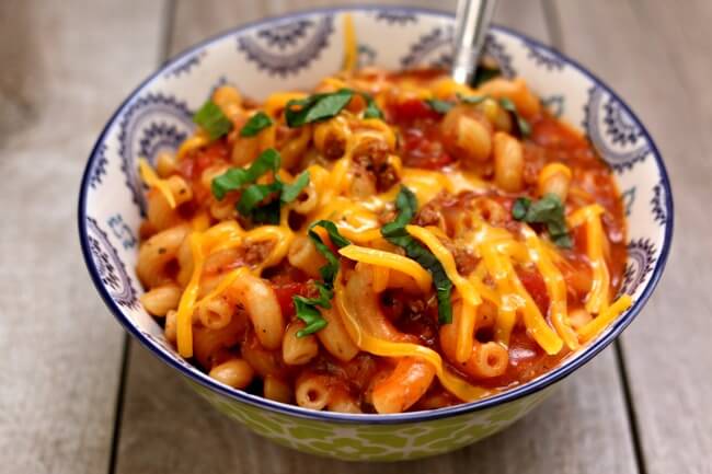 Instant Pot Old-Fashioned Goulash is an old family favorite recipe. Ground beef or turkey is browned and then simmered with a tomato-based sauce and macaroni noodles and then topped with grated cheddar. The perfect weeknight dinner to feed a family. Make it quickly in your electric pressure cooker.