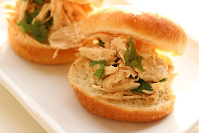 Slow Cooker Cilantro Lime Chicken Sliders--tender shredded chicken with lime and cilantro flavors served on a mini bun or roll. A super easy recipe that has loads of flavor.