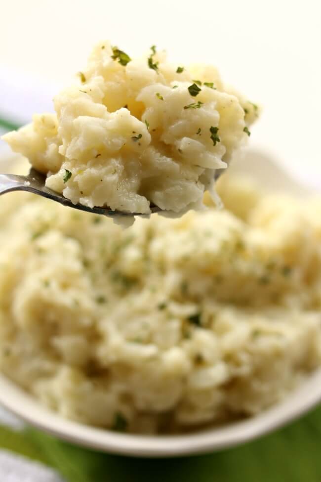 Slow Cooker Mashed Ranch Cauliflower--the yummiest cauliflower you'll ever eat! Cauliflower is cooked until soft and then mashed with butter and dry ranch dressing mix. An easy 3-ingredient recipe with lots of flavor. My only regret was that we didn't have enough.  
