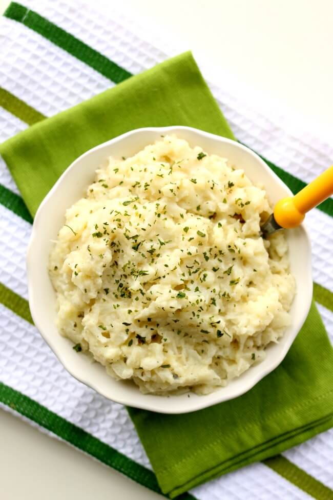 Slow Cooker Mashed Ranch Cauliflower--the yummiest cauliflower you'll ever eat! Cauliflower is cooked until soft and then mashed with butter and dry ranch dressing mix. An easy 3-ingredient recipe with lots of flavor. My only regret was that we didn't have enough.  