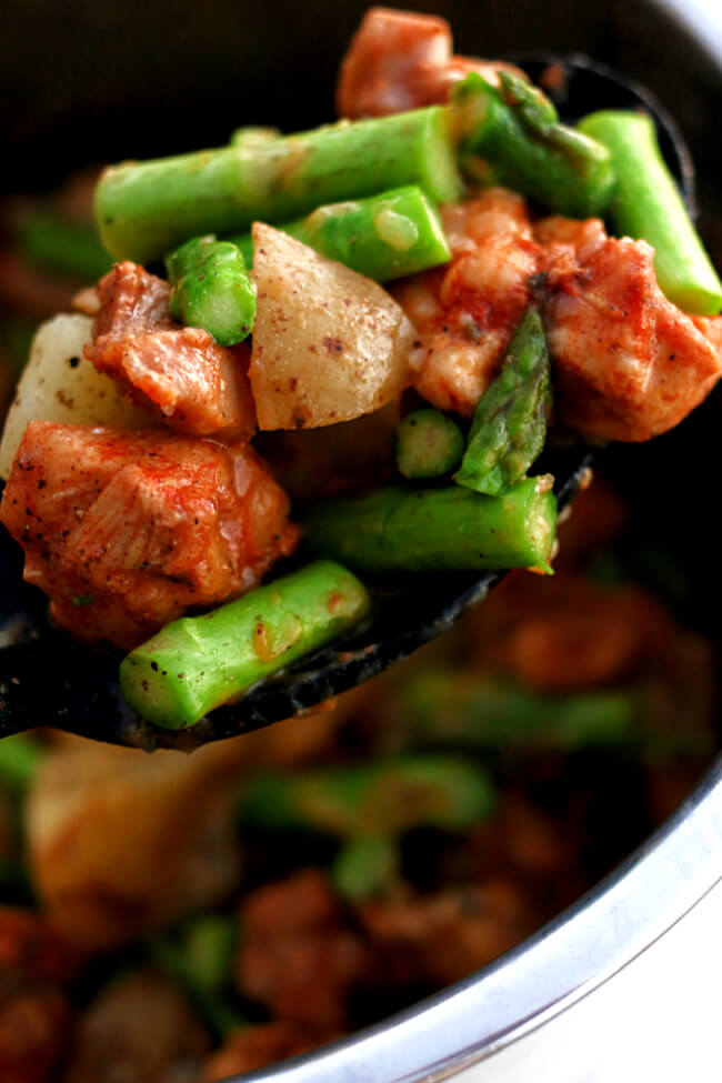 Instant Pot Chicken Asparagus Potato Dinner--moist bites of chicken, cubed potatoes and crisp bites of asparagus are tossed with a seasoning blend of smoked paprika, garlic powder and more to create a well seasoned one pot dinner. Use the Instant Pot to make this dinner quickly.