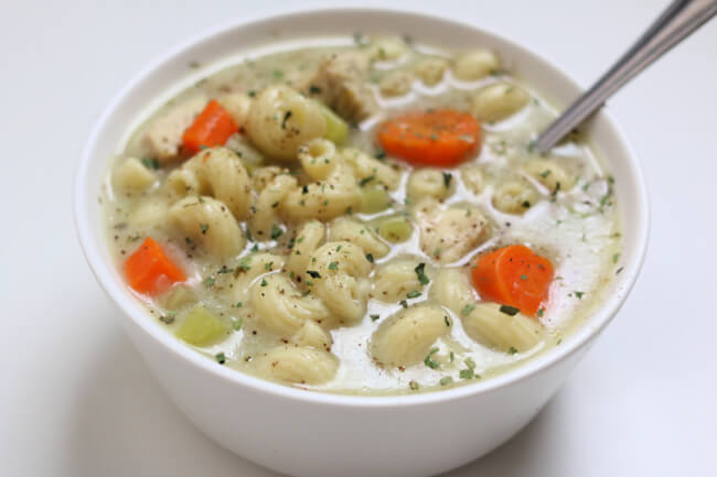 Instant Pot Creamy Chicken Noodle Soup--An easy and creamy chicken noodle soup recipe that is perfect for a cold day. Chicken, vegetables and pasta are all cooked together in one pot. And it's under 300 calories per serving! 