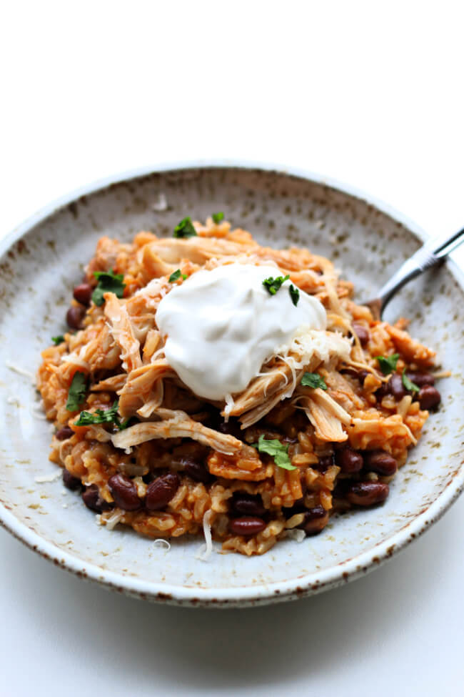 Instant Pot Chicken Rice Bowls--An easy dump and go recipe with chicken, rice (of your choice), enchilada sauce, black beans and spices. This is a perfect dinner for a busy weeknight or a good option to pack in individual containers for lunches during the week.  ï»¿