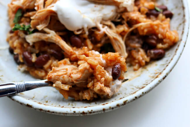 Instant Pot Chicken Rice Bowls--An easy dump and go recipe with chicken, rice (of your choice), enchilada sauce, black beans and spices. This is a perfect dinner for a busy weeknight or a good option to pack in individual containers for lunches during the week.  ﻿