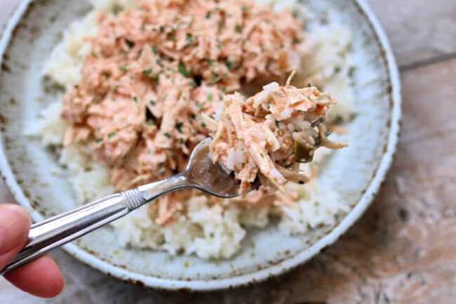 Instant Pot Fiesta Lime Chicken--shredded chicken with a creamy, flavorful sauce that's made quickly in your Instant Pot. And you can make rice at the same time in the same pot to serve with the chicken. An easy dinner for any night of the week. 
