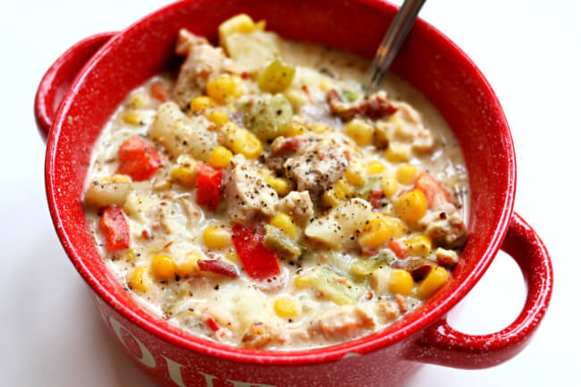Slow Cooker Chicken Bacon Chowder--this chowder is definitely a party in your mouth. With corn, chicken, bacon, cream cheese, potatoes, carrots, red bell pepper and more it's chock full of tastiness. You're going to be saying 