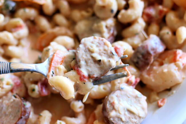 Instant Pot Cajun Sausage and Shrimp Pasta--a creamy sauce envelopes curly pasta, sliced sausage bites and tender shrimp. A recipe with amazing flavor that rivals anything you could order at a restaurant. 