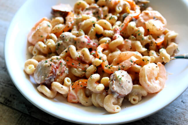 Instant Pot Cajun Sausage and Shrimp Pasta--a creamy sauce envelopes curly pasta, sliced sausage bites and tender shrimp. A recipe with amazing flavor that rivals anything you could order at a restaurant. 
