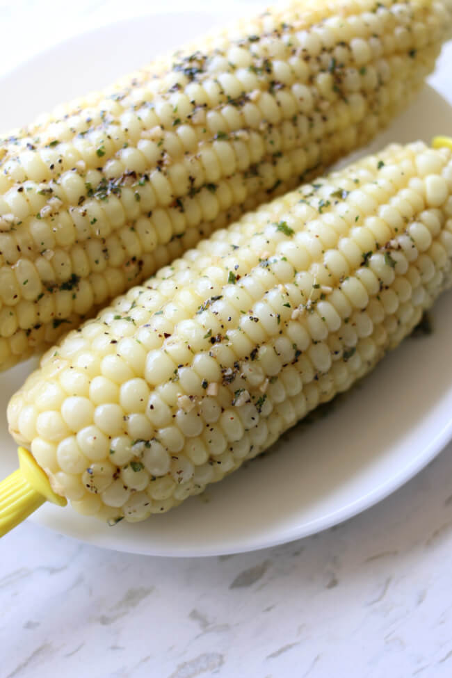 Instant Pot Garlic Butter Corn on the Cob--sweet corn is slathered with garlic, butter, salt and pepper. The easiest and tastiest corn on the cob! You'll never go back boiling corn on the stove again. 