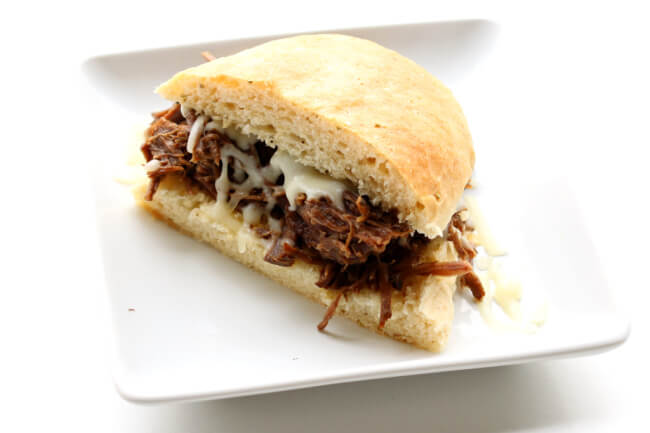 Instant Pot Garlic Beef Sandwiches--fork tender roast beef that is flavored with garlic and other filipino adobo flavors. Perfect to serve on rolls or over rice for a quick and easy dinner that can feed a crowd. 
