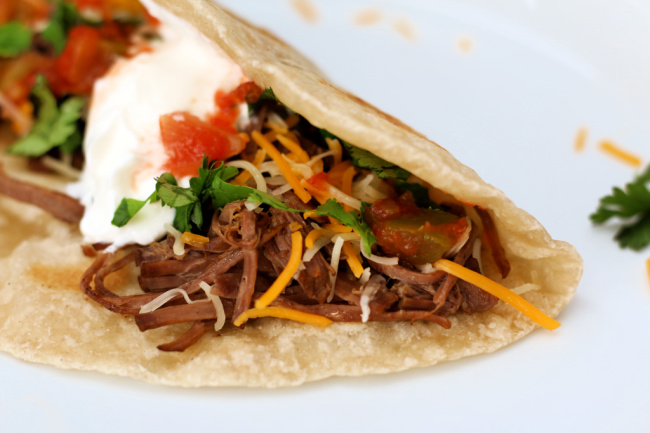 Instant Pot Beef Barbacoa--flavorful, seasoned beef chuck roast that shreds like a dream and is perfect for so many different dinners. Try this barbacoa beef in cheesy quesadillas, crispy tacos, rolled up as enchiladas or piled on top of nachos. 