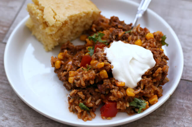 Cheesy, meaty and hearty this Instant Pot Cheesy Taco Rice has lots of flavor from corn, picante sauce, tomatoes, beef, brown rice and cheese. This recipe will quickly become a weeknight favorite. 