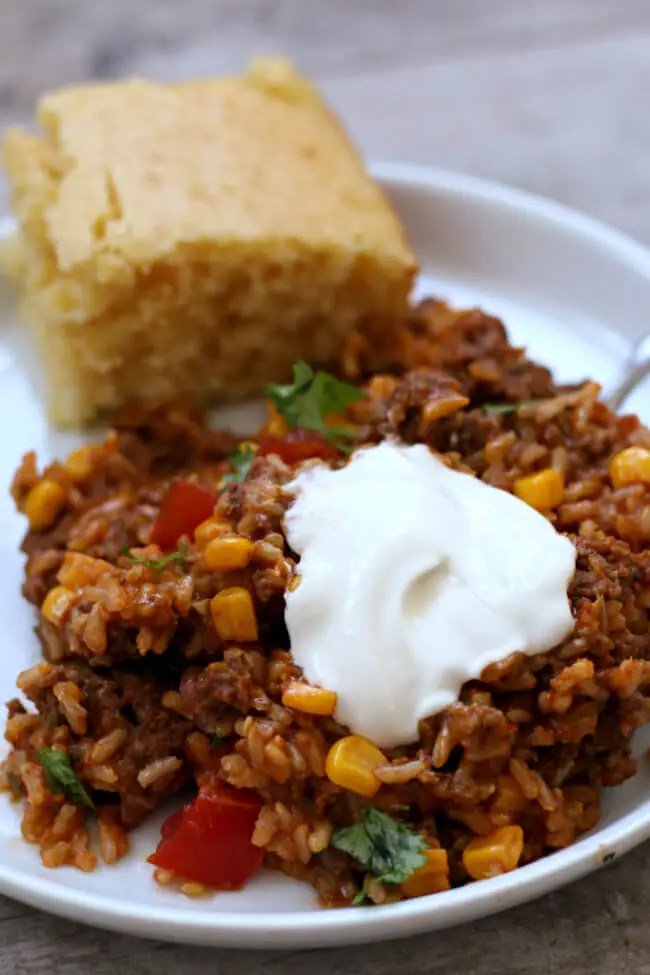 Cheesy, meaty and hearty this Slow Cooker Cheesy Taco Rice has lots of flavor from corn, picante sauce, tomatoes, beef, brown rice and cheese. This recipe will quickly become a weeknight favorite. 