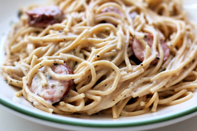 Instant Pot Alfredo Sausage Pasta--flavorful bites of smoked sausage with a creamy (but skinny) sauce that envelopes spaghetti noodles. 