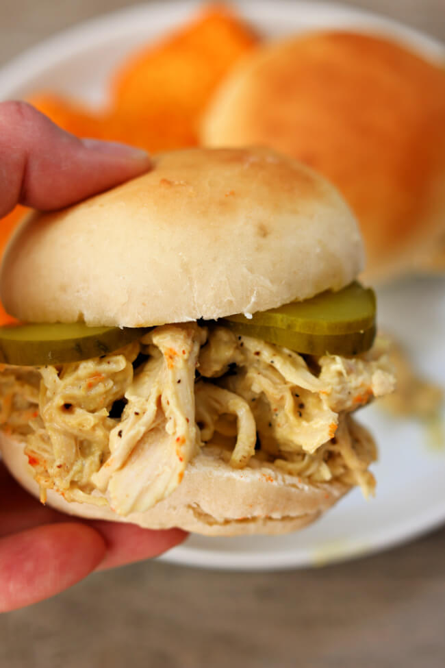 Slow Cooker Honey Mustard Chicken Sandwiches--tender shredded chicken coated with a honey mustard sauce and then served with pickles on top of freshly baked buns.