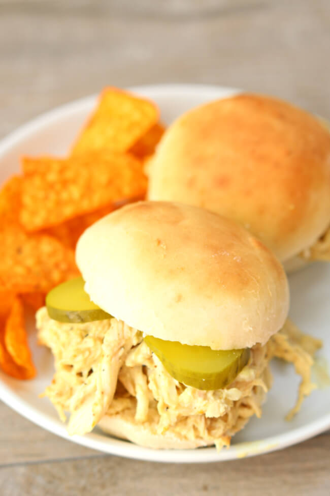 Instant Pot Honey Mustard Chicken Sandwiches--tender shredded chicken coated with a honey mustard sauce and then served with pickles on top of freshly baked buns.