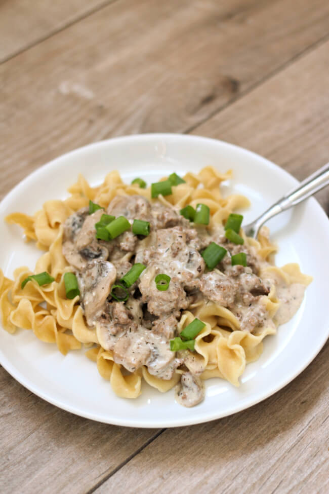 Instant Pot Ground Beef Stroganoff--a creamy mushroom sauce with ground beef served over egg noodles. An easy recipe to make that uses common ingredients and it's delicious to eat. 