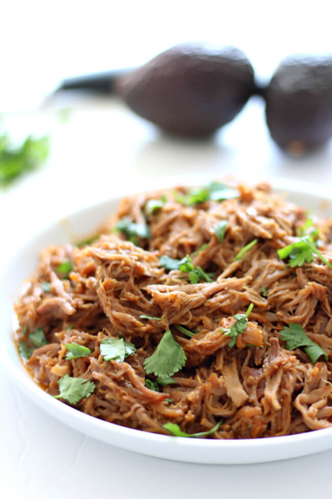 Slow Cooker Cafe Rio Sweet Pork--make your favorite restaurant's sweet pork at home with just a handful of ingredients. This pulled pork is perfect over salad, rice, tacos, burritos, quesadillas or on a toasted bun. 