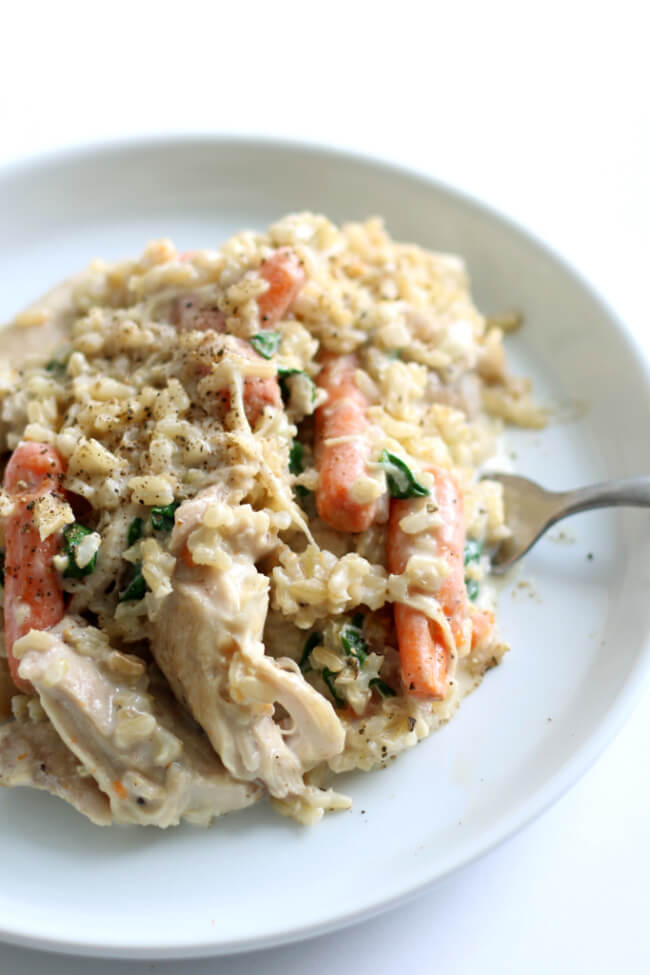Slow Cooker Creamy Chicken Rice Dinner--a simple chicken and rice dinner with carrots and spinach. It's creamy but doesn't have any 