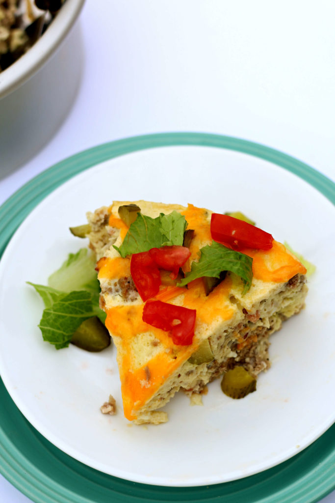 Slow Cooker Cheeseburger Breakfast Casserole--a low carb egg dish that has bacon, beef, cheddar and pickles. This easy quiche-like dish is perfect for breakfast or dinner. It reminds of the Starbucks egg bites. 