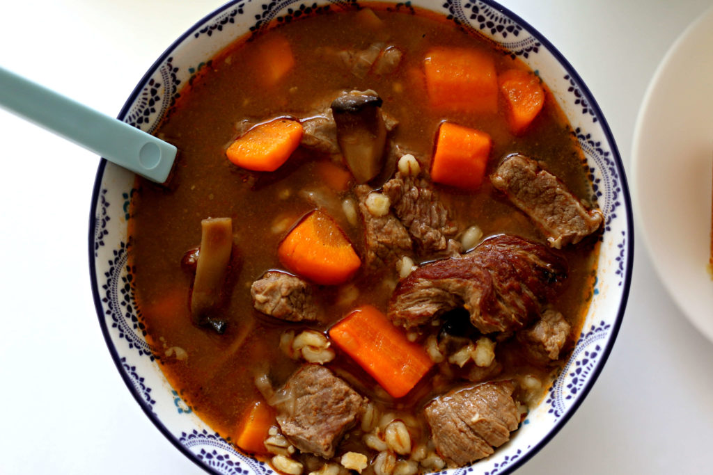 Slow Cooker Beef and Barley Soup--a savory brothy soup with tender bites of beef, chewy barley and vegetables. Let it simmer all day in your slow cooker. 