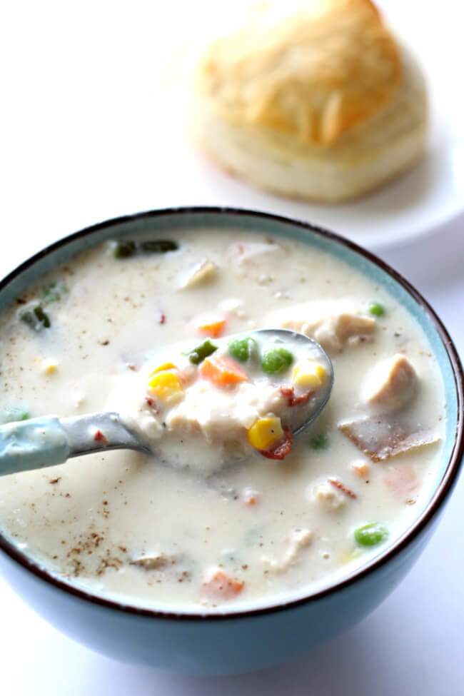Slow Cooker Chicken Pot Pie Soup--all the flavors from chicken pot pie in a soup! This super easy recipe is made in in your slow cooker. It can be made with raw chicken or leftover cooked turkey or chicken. Serve the soup topped with a biscuit to make it feel like the crust of a pot pie. 