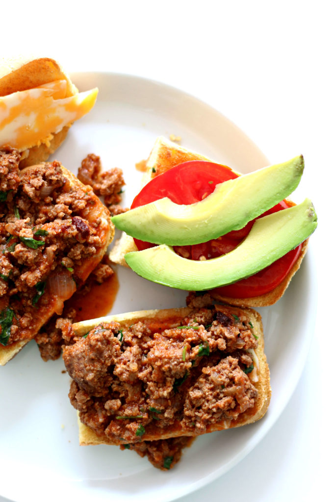 Slow Cooker Southwest Tavern Sandwiches--a loose meat sandwich seasoned with southwest flavors and then topped with cheese, avocado and tomato. A perfect dinner or lunch to feed a crowd. 