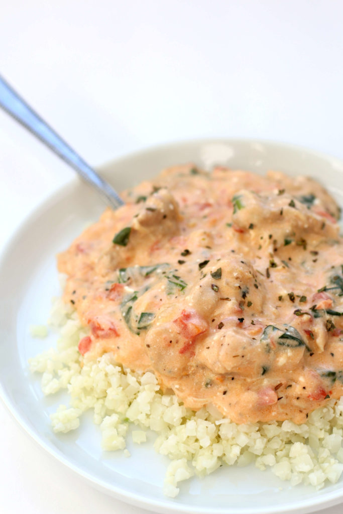 Instant Pot Creamy Tomato Spinach Chicken--chunks of chicken smothered in a flavorful cream cheese and tomato sauce and then served over noodles, potatoes or rice. 