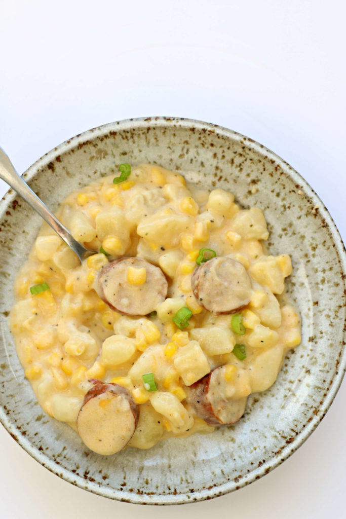 Instant Pot Cheesy Potatoes and Sausage--potatoes, smoked sausage and corn enveloped in a cheddar and sour cream sauce. A perfect dinner or a side dish for a potluck. 