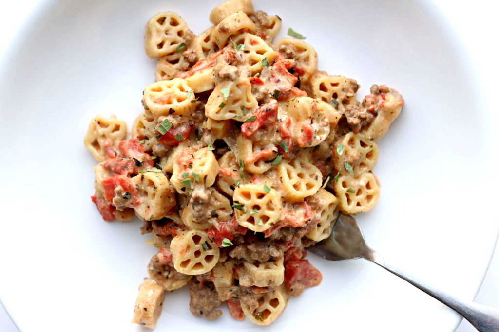 Instant Pot Pioneer Pasta--wagon wheel pasta and ground beef are cooked with fire roasted tomatoes, seasonings, cream cheese and pepper jack cheese for a pasta dish that has tons of flavor. Kids and adults love this meal!