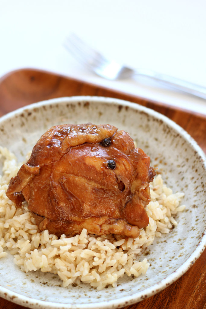 brown chicken on a plate with rice
