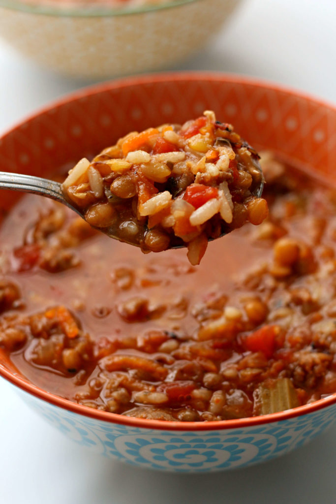 Slow Cooker Sausage Lentil Rice Soup--a flavorful hearty soup with chunks of sausage, lentils, rice, fire roasted tomatoes and seasonings. Give it a shot for dinner this week! 