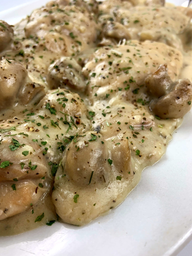 chicken and mushrooms with a brown gravy sauce