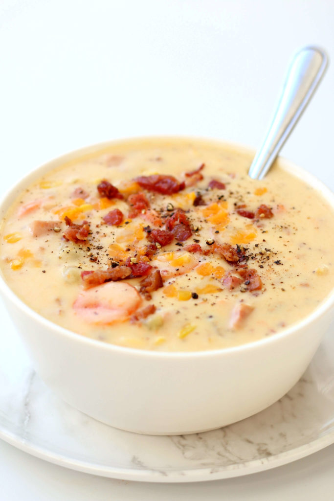 white bowl with creamy soup and bacon bits