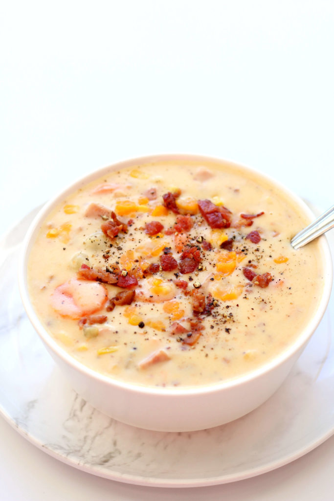 white bowl with creamy soup and bacon bits