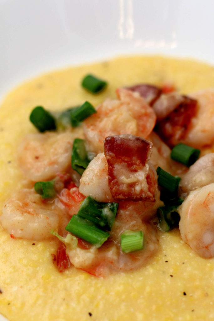 shrimp and grits in a white bowl