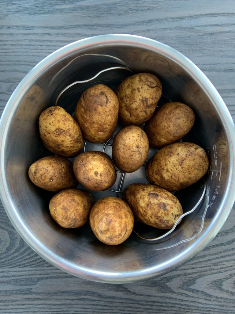 baked potatoes in an instant pot lined up vertically