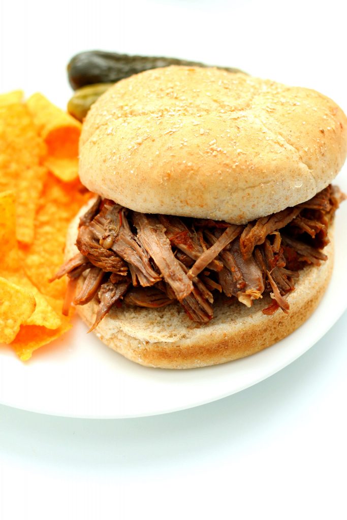 beef sandwich on a white plate